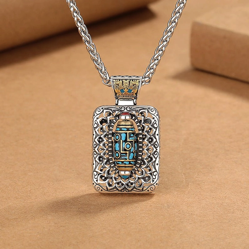 Nine-Eye Dzi Bead rotatable copper pendant necklace front view with intricate carved design, nine-eye Buddhist symbol, 360-degree rotating mechanism
