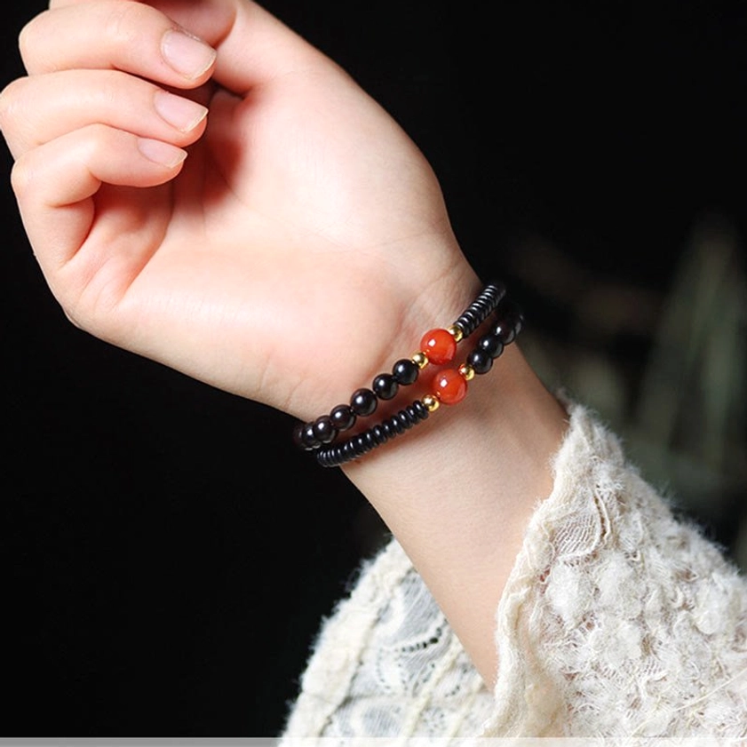 Detail shot of hand-painted dzi bead with nine-eye pattern symbolizing protection, luck, and wisdom in sacred Buddhist jewelry