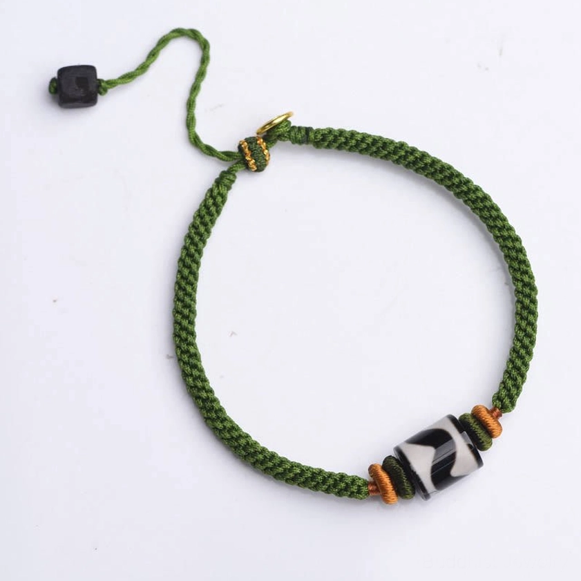Nine-eye dzi bead green rope bracelet detail shot showcasing handcrafted quality and authentic agate stone