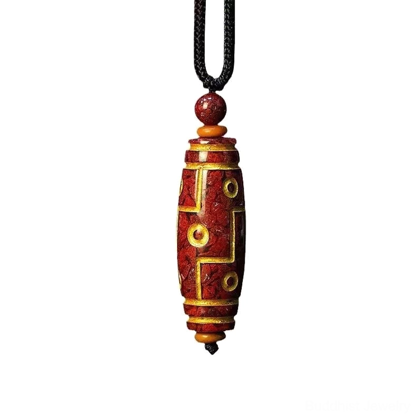 Nine-eye dzi bead Buddhist necklace pendant hanging view, showing crimson stone with gold decorative patterns on white background
