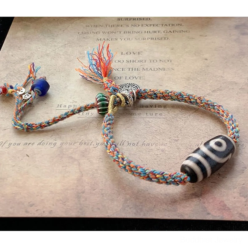 Nine-Eye Dzi Bead Sterling Silver protection bracelet gift packaging featuring sacred mantra and spiritual significance for conscious gifting