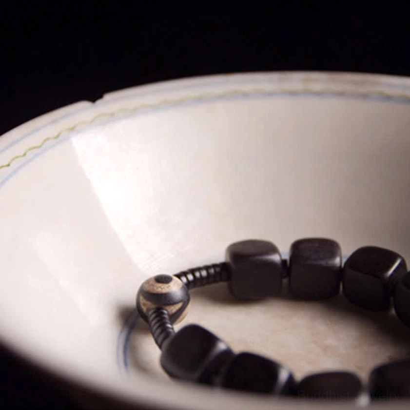Hand-painted nine-eye dzi bead bracelet with ebony wood for strength, protection, and inner wisdom