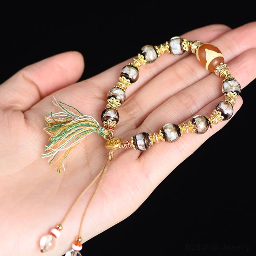 Hand-crafted nine-eye dzi bead bracelet showing five elements color variations and spiritual significance