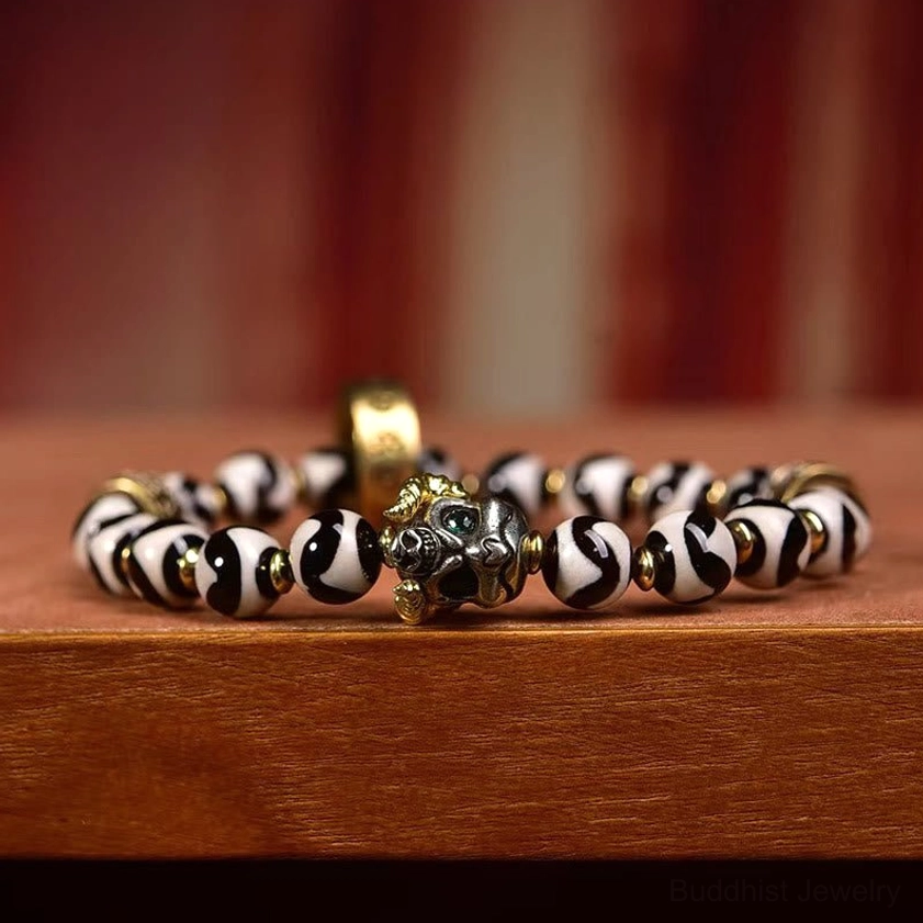Eye-Level Side View of Sacred Nine-Eye Dzi Buddhist Bracelet with Stacked Beads and Shiny Metal Decorative Elements
