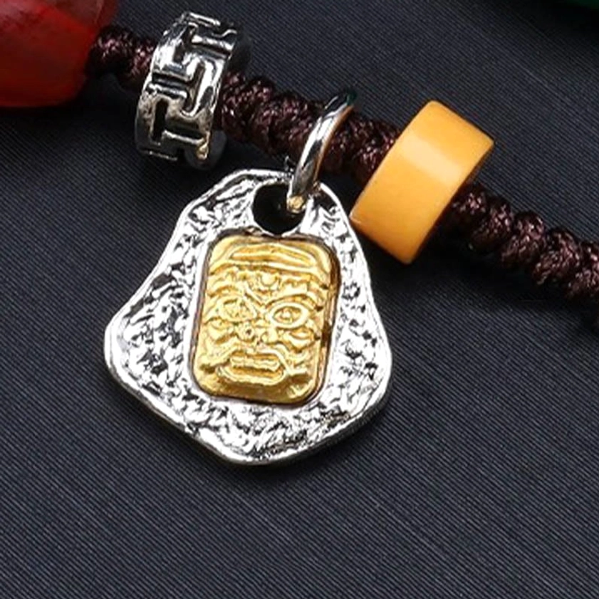 Nine-eye dzi bead Buddhist necklace component parts including Tibetan silver engraved pendant, yellow wooden spacer beads, and woven rope fastener