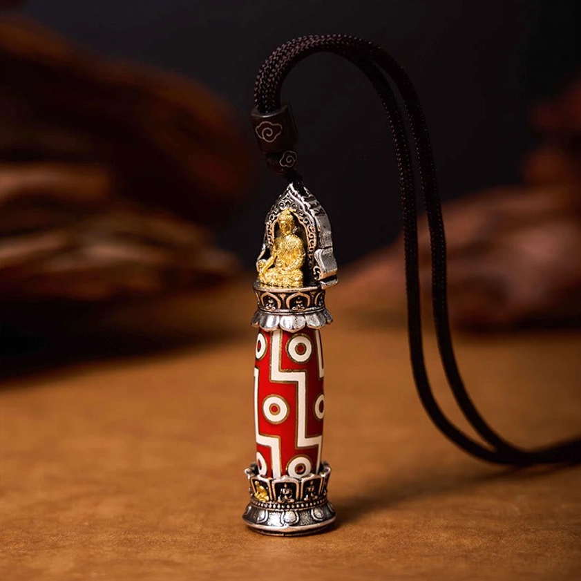 Handmade Medicine Buddha Nine-Eye Dzi protection pendant with antique silver frame and geometric pattern details