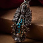 Nine-eye dzi bead turquoise buddha wealth necklace pendant with intricate filigree carvings and turquoise inlays for protection and prosperity
