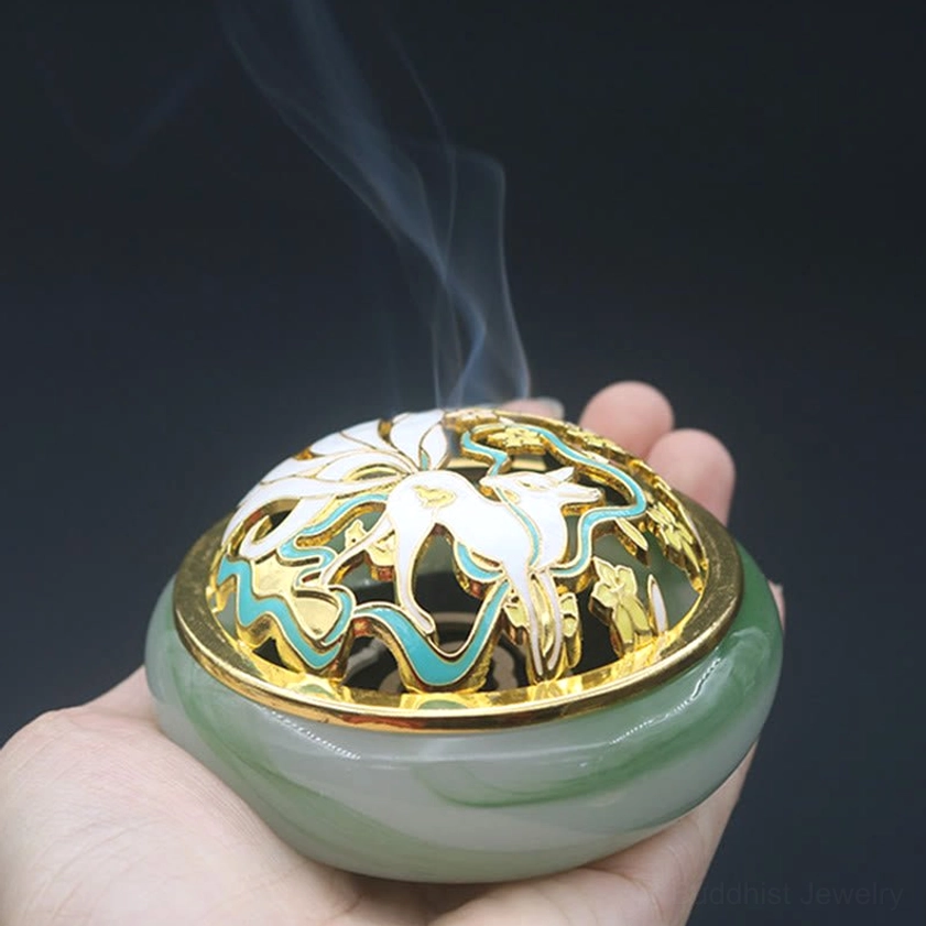 Handcrafted nine-tailed fox liuli crystal incense burner detail shot of intricate cloisonne artwork and gold-trimmed decorative lid with sacred symbols