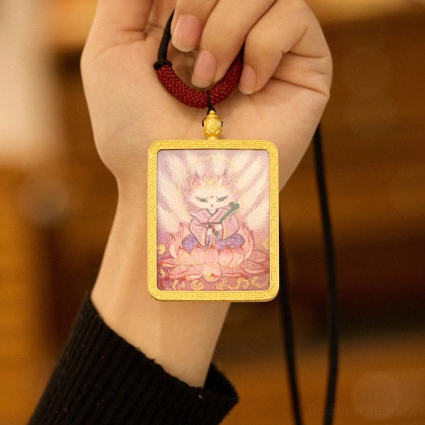 Nine-tailed fox Thangka pendant held in hand showing pink lotus fox design with gold frame close-up view
