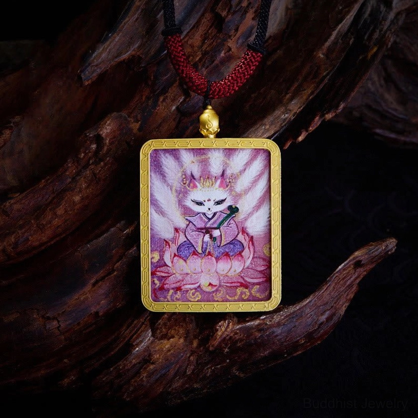 Nine-tailed fox Buddhist Thangka pendant featuring pink lotus design and red braided necklace cord on wooden backdrop