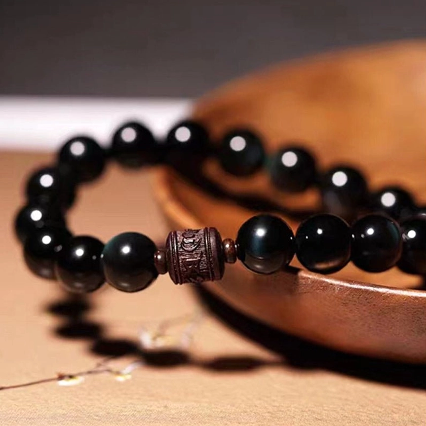 Obsidian bracelet collection showing various bead sizes 8mm 10mm 12mm with different spiritual symbol engravings