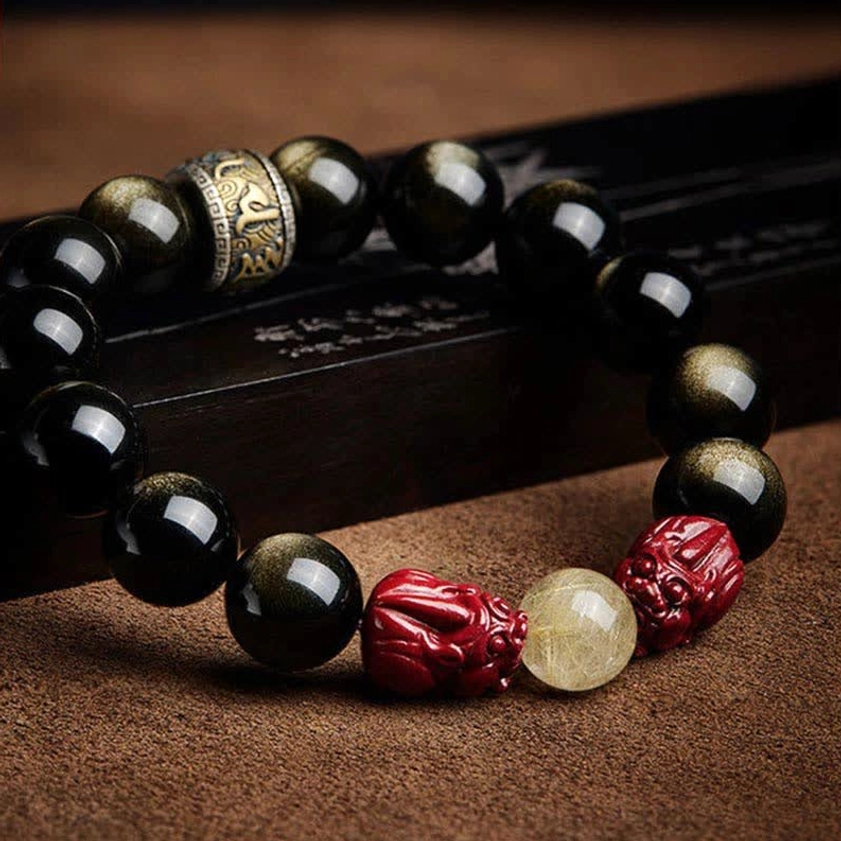 Buddhist prayer bracelet with carved om mani padme hum mantra spacer, obsidian beads, and pixiu charm