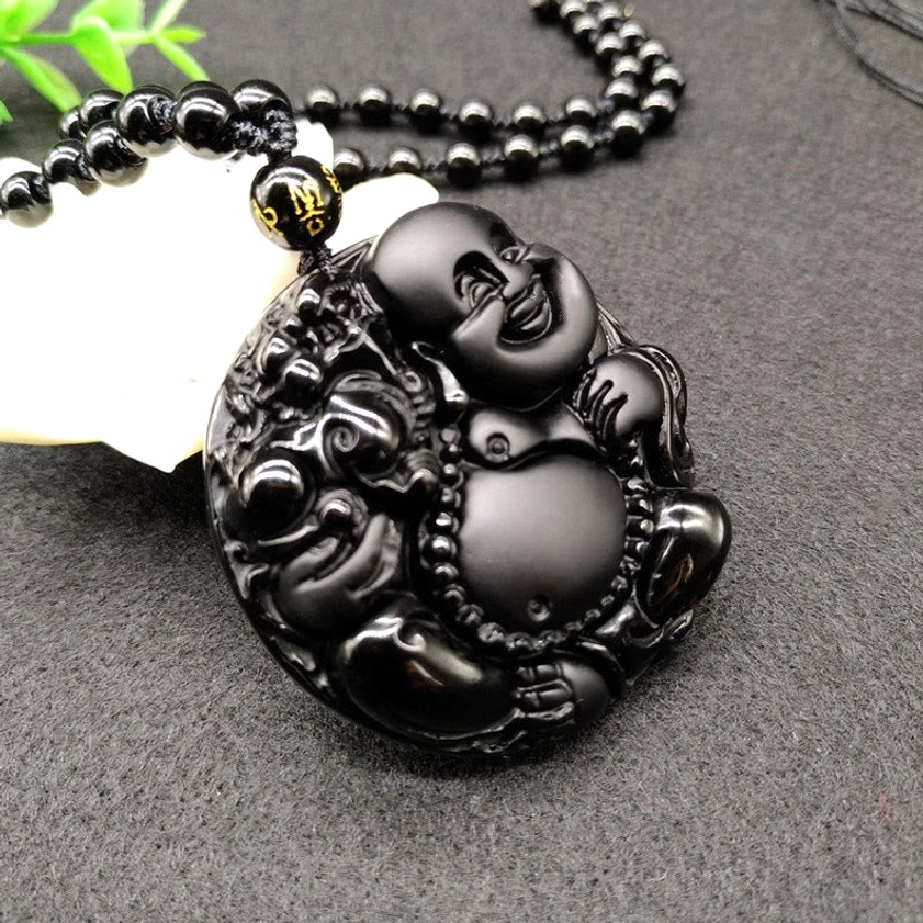 Black Obsidian Buddhist pendant necklace with branded spacer bead on beaded chain, side profile view
