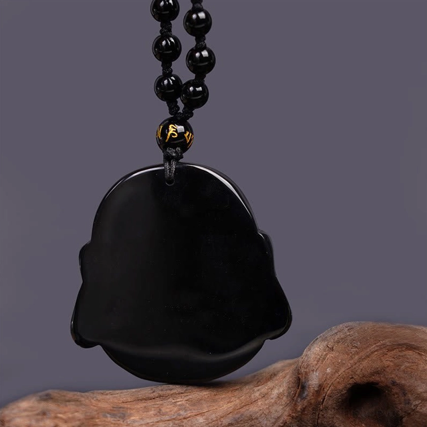 Black obsidian Buddha pendant back view, showing flat uncarved rear surface and chain attachment point