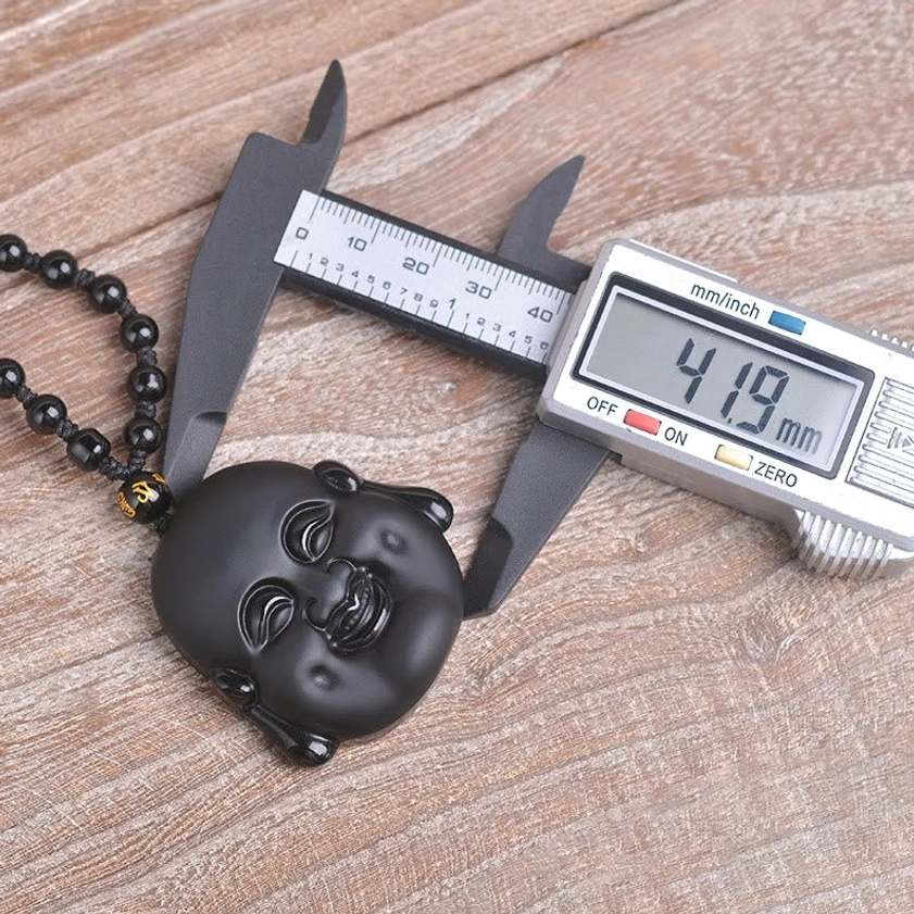 Black obsidian Buddha pendant necklace with digital caliper measuring 41.9mm height, size specification detail