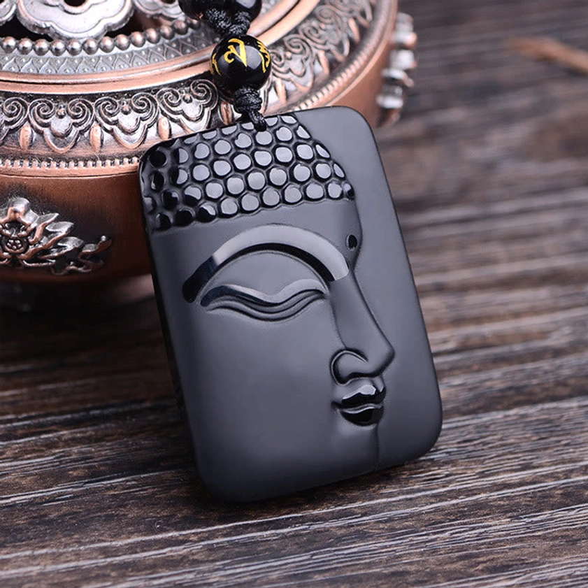 Black Obsidian Buddha Pendant Side View - 3/4 close-up showing detailed Buddha's facial features with polished high-gloss black obsidian surface