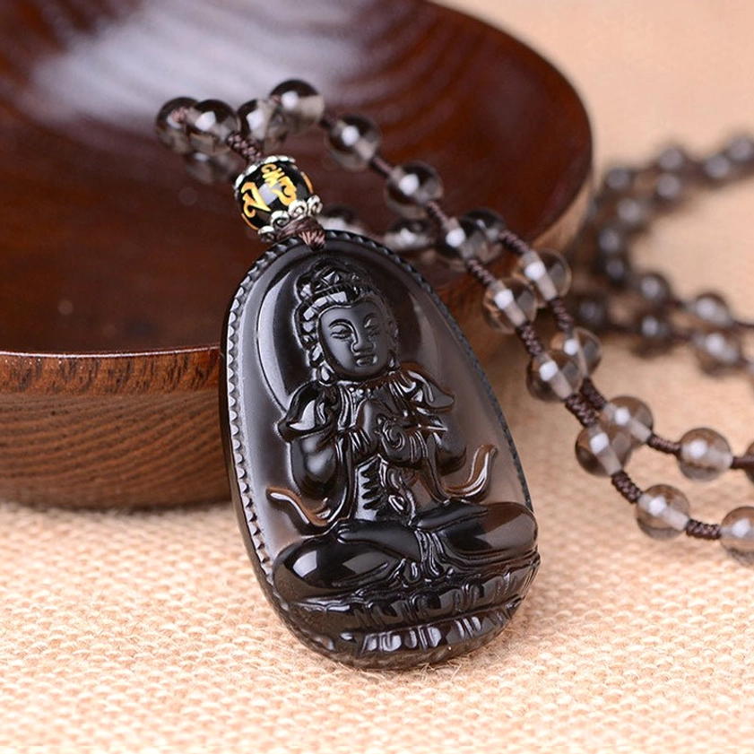 Hand-carved black obsidian seated Buddha pendant with inscribed bead accents on chain, left-bottom view