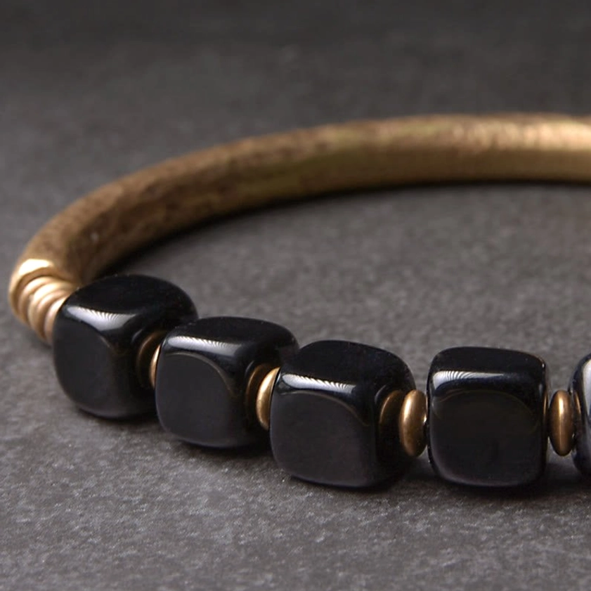 Black obsidian crystal cube beads with hammered gold metal accents side close-up detail