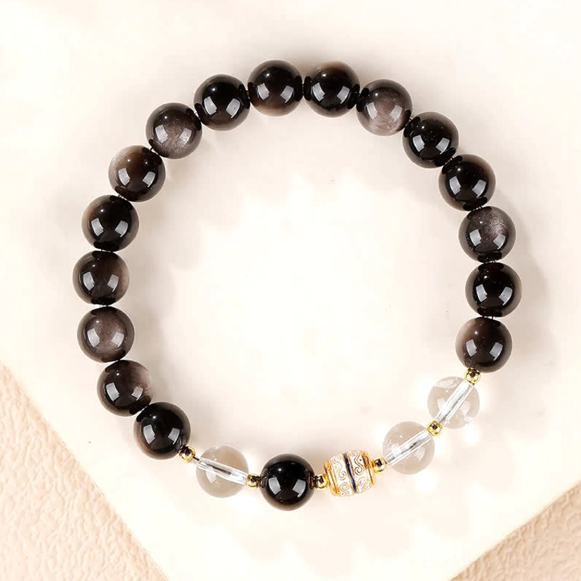 Full circle layout of silver sheen obsidian Buddhist bracelet showing complete bead design with clear spacers and gold decorative elements