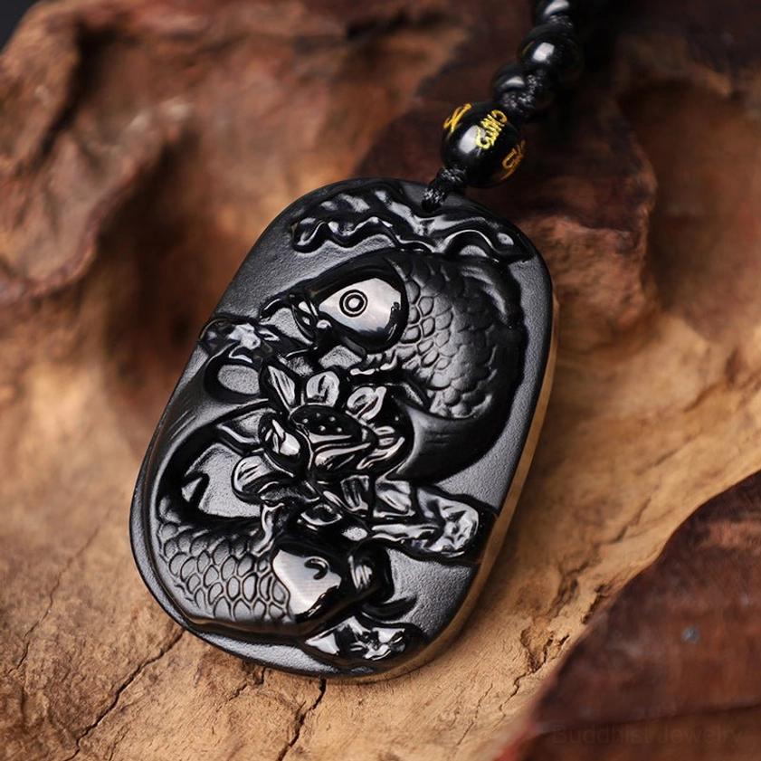 Close-up detail of Black Obsidian Koi Fish Lotus Carved Pendant - top-down view highlighting intricate carving work