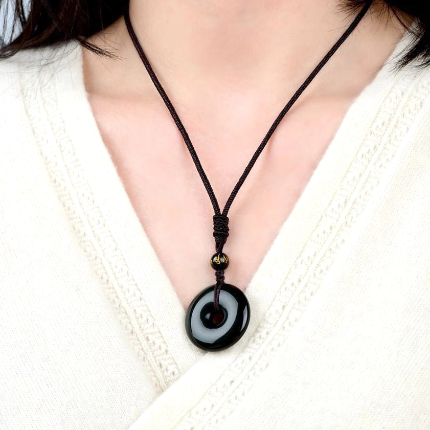 Black obsidian donut pendant necklace worn on neck - wearable styling