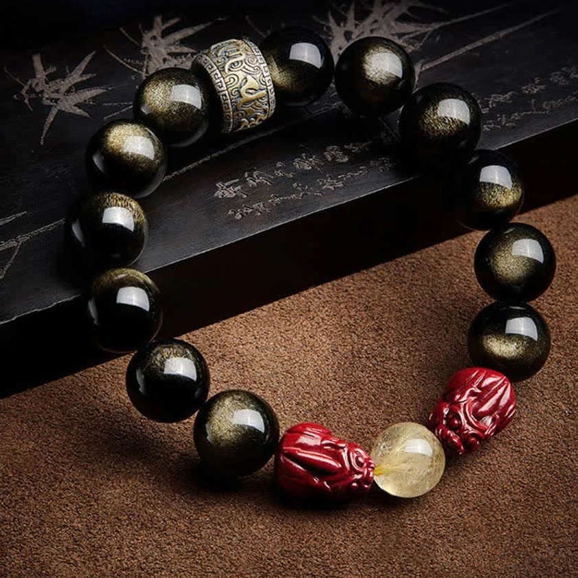 Handmade Buddhist bracelet featuring obsidian beads, red pixiu charm, and engraved metal spacer on brown leather