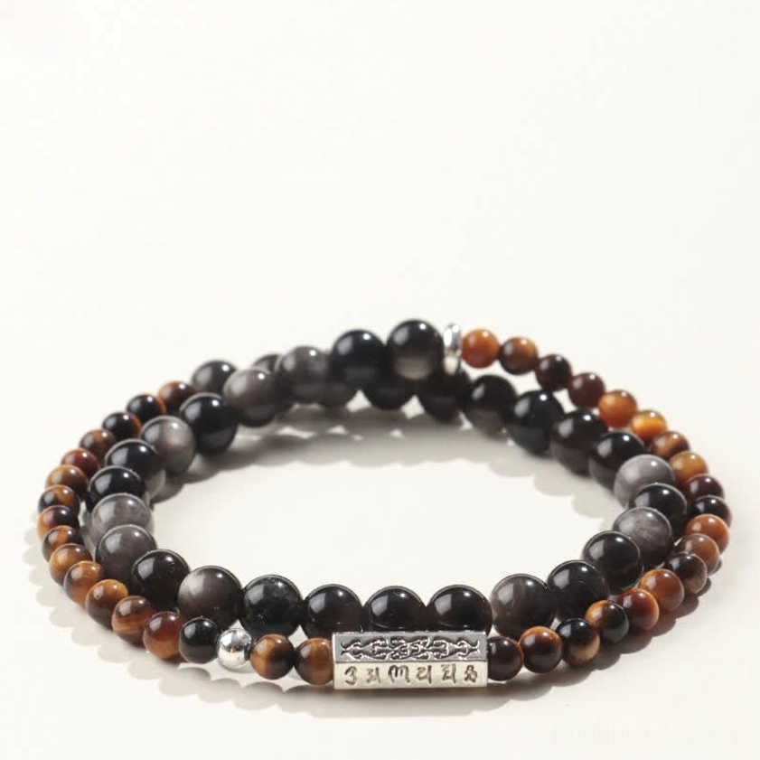 Top view of brown gradient obsidian beaded bracelet with dark stone and engraved silver spiritual charm, showcasing double wrap elastic design