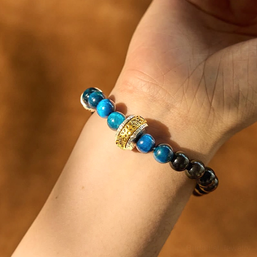Silver sheen obsidian blue tiger eye protection bracelet worn on wrist, showing natural stone bead arrangement