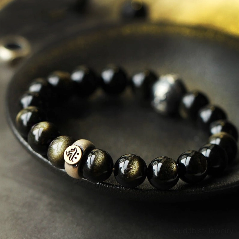 Gold sheen obsidian Buddhist zodiac natal Buddha bracelet with sterling silver beads, top-down view