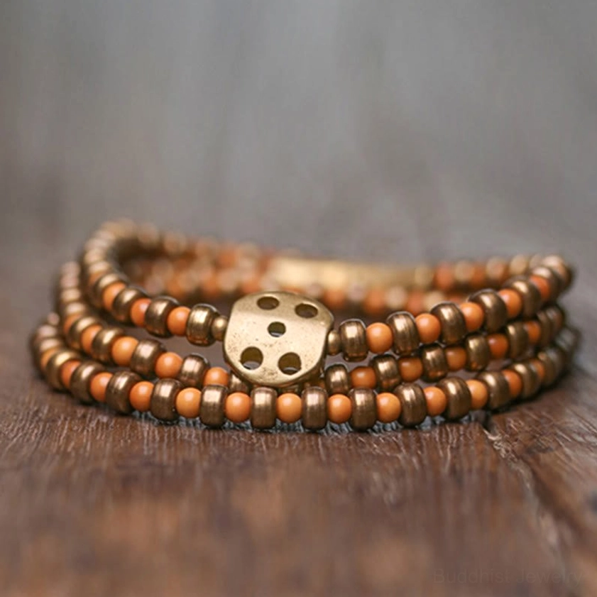 Stacked multi-layer olive pit copper bracelet showing layered bead strands and hollow bronze round clasp