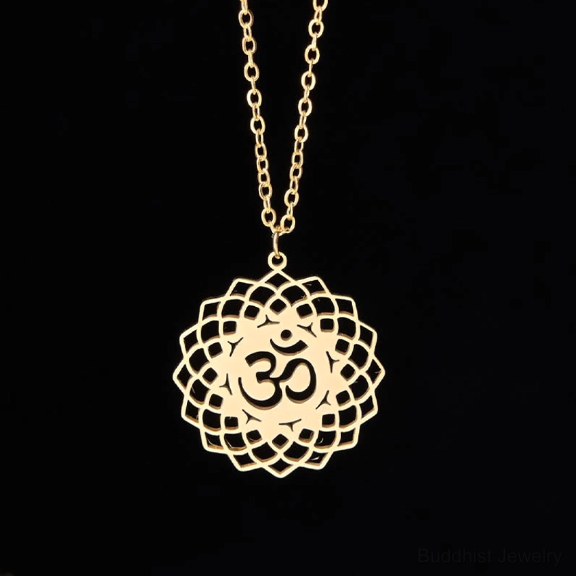 Gold polished Om lotus Buddhist necklace pendant flat lay close-up