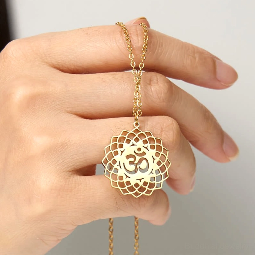 Gold Om symbol within lotus frame held in hand Buddhist necklace