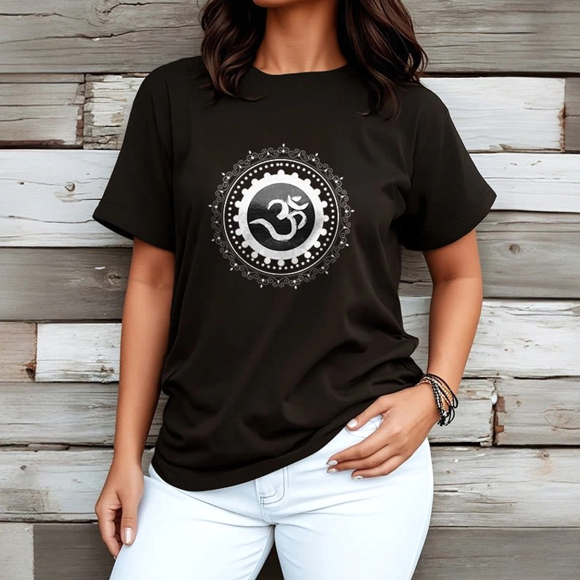 Woman wearing black Om Mandala spiritual t-shirt with white jeans - wooden wall background mindfulness fashion