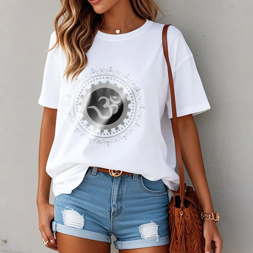 Woman wearing white Om Mandala spiritual t-shirt with denim shorts and crossbody bag - casual daily Buddhist fashion styling