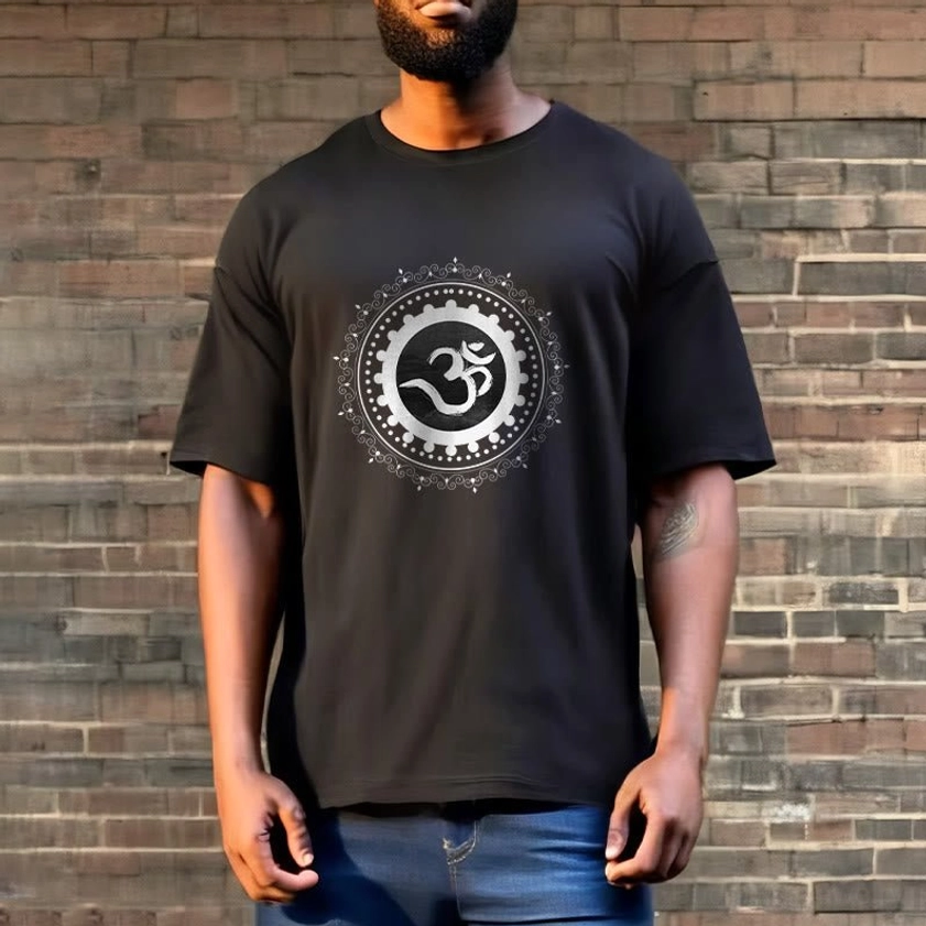 Male model wearing black Om Mandala t-shirt against brick wall - soft cotton fabric spiritual apparel