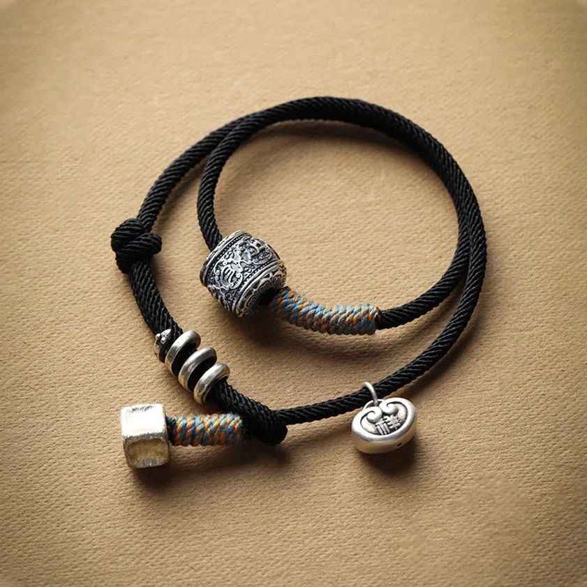 Black double-wrap mantra bracelet with hand-carved beads and lock charm pendant
