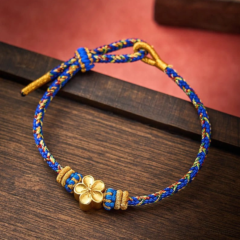 Blue Om Mani Padme Hum bracelet with decorative flower accessory charm attached