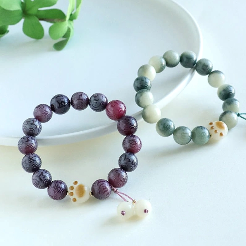 Om Mani Padme Hum Buddhist bracelet displayed on meditation altar with spiritual ambiance and sacred context