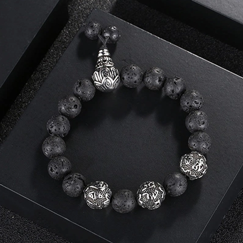 Buddhist prayer bracelet with adjustable toggle clasp showing porous lava rock beads and silver mantra bead details