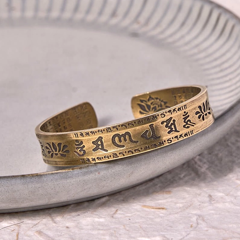 Om Mani Padme Hum adjustable cuff bracelet with lotus flower carving and ancient Sanskrit text
