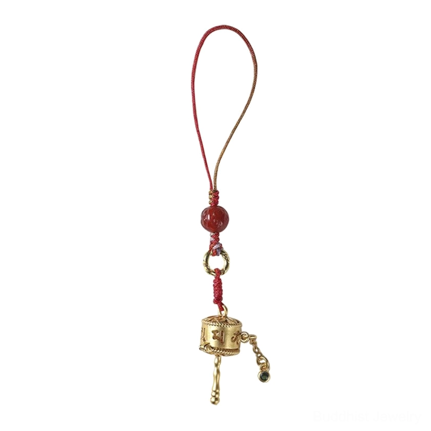 Om Mani Padme Hum Buddhist prayer wheel amulet charm showing intricate gold-plated details and red agate beads