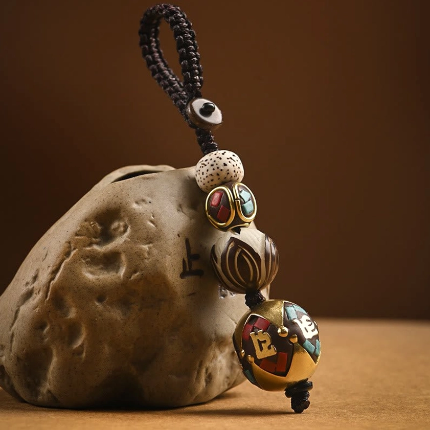 Om Mani Padme Hum Bead keychain variant featuring carved mantra bead with brass accents