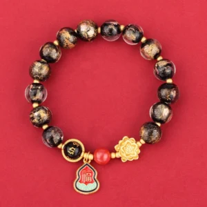 Black Liuli glass Buddhist bracelet with Om Mani Padme Hum charm, lotus pendant, and Fu character gourd on red background