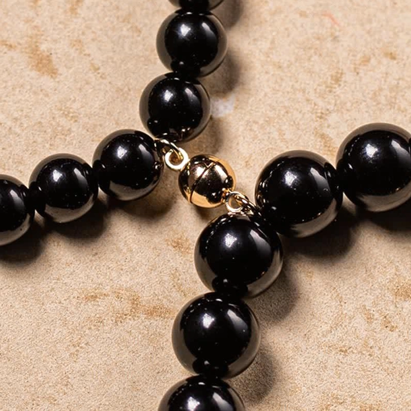 Black obsidian and jade Buddhist bracelet with sacred om mani padme hum mantra, symbolizing compassion and enlightenment