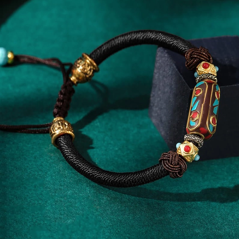 Black color variant of handmade Buddhist Om Mani Padme Hum braided bracelet with enamel charm and adjustable turquoise bead cord