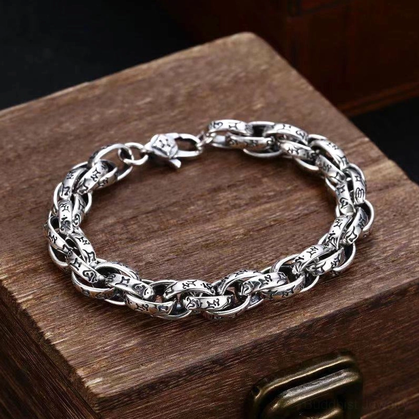 Om Mani Padme Hum carved copper bracelet with antique silver finish, top-down view showing intricate engraved mantra detail