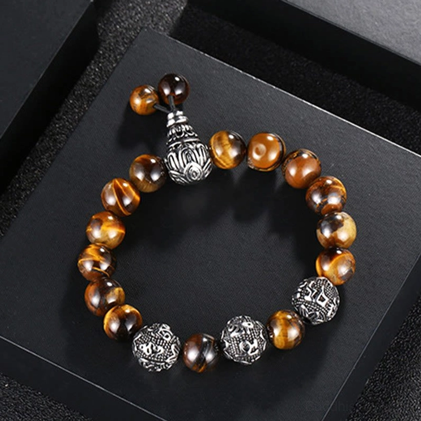 Six True Words mantra bracelet laid flat in black jewelry display box showing circular arrangement of tiger eye and silver mantra beads