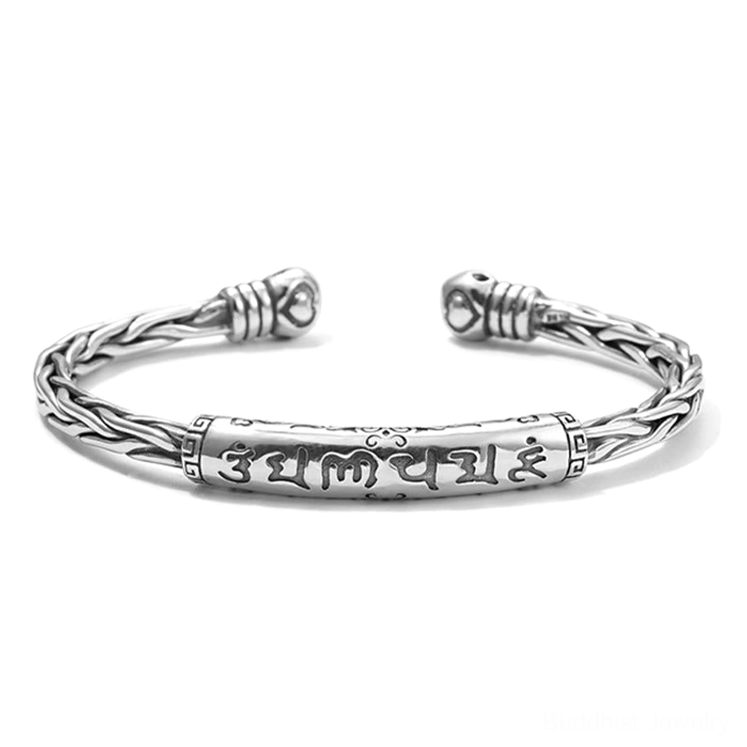 Flat overhead view of Sanskrit mantra engraved Buddhist bangle showing full Om Mani Padme Hum inscription