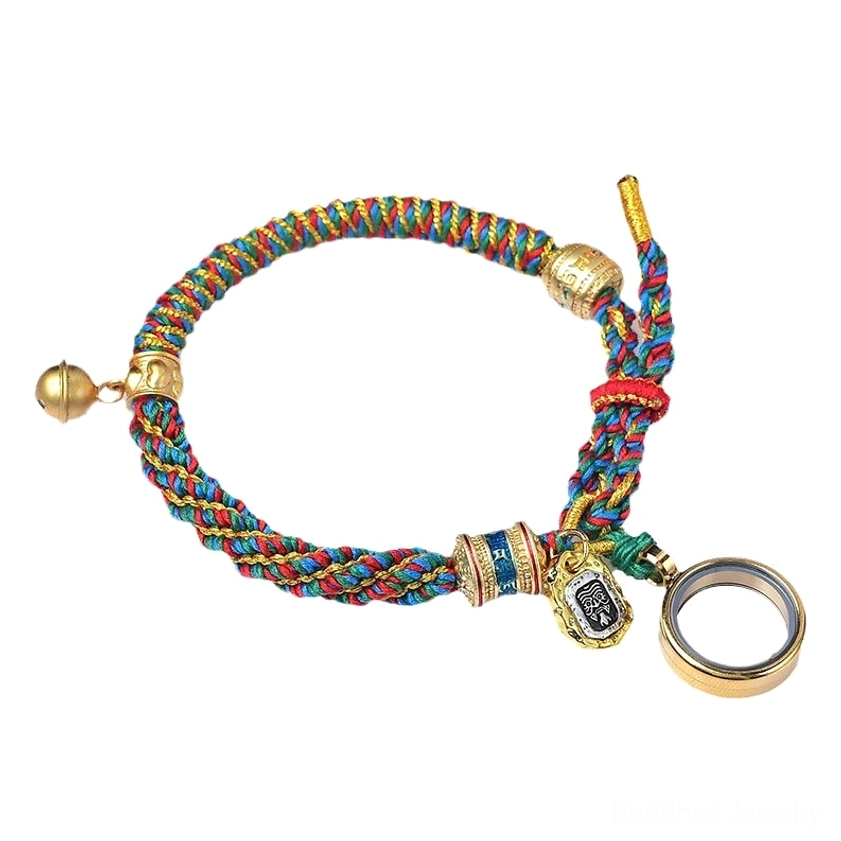 Flat lay view of Buddhist mantra bracelet with multicolored braided rope, brass bell and round metal charm on white background