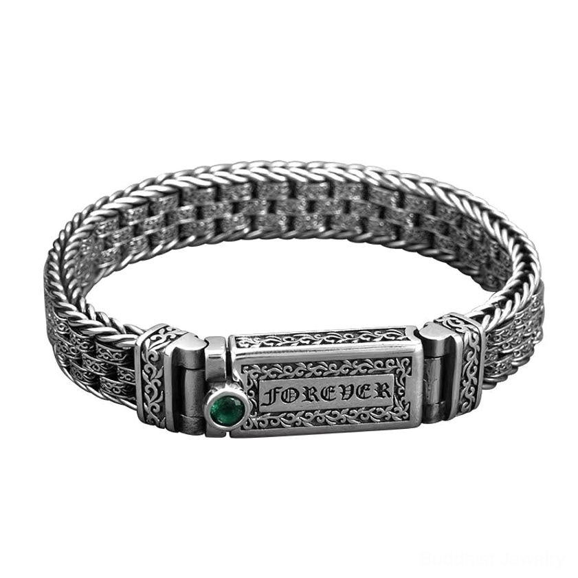 Om Mani Padme Hum mantra bracelet flat lay showing engraved sacred text, floral ornaments, and green gemstone